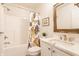 Bathroom features a tub with shower, toilet, and single vanity with a wood framed mirror above at 9237 Rocky Cay Ct, Zionsville, IN 46077