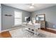 Stylish bedroom featuring a large desk, hardwood floors, a cozy rug, and ample natural light at 9237 Rocky Cay Ct, Zionsville, IN 46077