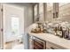 Butler's pantry featuring gray cabinets, wine storage, mosaic tile backsplash and access to a half bathroom at 9237 Rocky Cay Ct, Zionsville, IN 46077