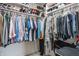 Well-organized closet with shelves stocked with shoes and clothing neatly hung on rods at 9237 Rocky Cay Ct, Zionsville, IN 46077