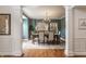 Elegant dining room featuring wainscoting, hardwood floors, chandelier, and a neutral color palette at 9237 Rocky Cay Ct, Zionsville, IN 46077
