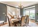 Dining room with hardwood floors, a large window, and a dining table set for six, offering an inviting atmosphere at 9237 Rocky Cay Ct, Zionsville, IN 46077