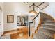 The home's foyer features an elegant staircase, hardwood floors, and a view into the dining room at 9237 Rocky Cay Ct, Zionsville, IN 46077
