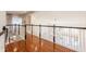 View from the second floor landing shows the chandelier, hardwood floor, and staircase with black railing at 9237 Rocky Cay Ct, Zionsville, IN 46077