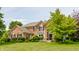 Charming brick home with manicured lawn, lush landscaping and mature trees creating a warm and inviting curb appeal at 9237 Rocky Cay Ct, Zionsville, IN 46077