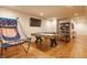 Finished basement game room with basketball arcade, ping pong table, and hardwood floors at 9237 Rocky Cay Ct, Zionsville, IN 46077