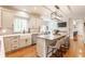 Open kitchen featuring white cabinets, quartz countertops, a large island, and hardwood floors, perfect for entertaining at 9237 Rocky Cay Ct, Zionsville, IN 46077
