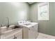 Basement laundry room featuring sink, washer and dryer with a window for natural light at 9237 Rocky Cay Ct, Zionsville, IN 46077