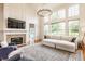 Bright living room featuring a cozy fireplace, comfortable seating, and large windows for ample natural light at 9237 Rocky Cay Ct, Zionsville, IN 46077
