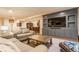 Finished basement Gathering room with built in entertainment center, bar and ample seating at 9237 Rocky Cay Ct, Zionsville, IN 46077