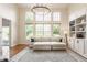 Bright living room with soaring ceilings, large windows, built-in shelving, and comfortable seating, creating an inviting atmosphere at 9237 Rocky Cay Ct, Zionsville, IN 46077