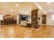 Open concept finished basement with bar, entertainment center, and hardwood flooring at 9237 Rocky Cay Ct, Zionsville, IN 46077