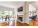 Inviting living room with a cozy fireplace, and views to additional living spaces and a dining area at 9237 Rocky Cay Ct, Zionsville, IN 46077