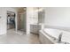 Bright primary bathroom features a separate shower, walk-in closet and soaking tub for the ultimate relaxation at 9237 Rocky Cay Ct, Zionsville, IN 46077