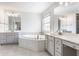 The main bathroom features double vanities and a large soaking tub, offering a relaxing retreat at 9237 Rocky Cay Ct, Zionsville, IN 46077