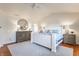 A spacious primary bedroom offers hardwood floors, a shiplap accent wall, and ample natural light at 9237 Rocky Cay Ct, Zionsville, IN 46077