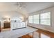 The primary bedroom features hardwood floors, shiplap accent wall, and natural light from large windows at 9237 Rocky Cay Ct, Zionsville, IN 46077