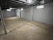 A view of an unfinished basement with support poles and cinder block walls at 937 N Routiers Ave, Indianapolis, IN 46219