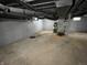 A view of an unfinished basement with support poles, a water heater and exposed duct work at 937 N Routiers Ave, Indianapolis, IN 46219