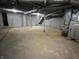 A view of an unfinished basement with support poles, a water heater and exposed duct work at 937 N Routiers Ave, Indianapolis, IN 46219