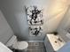 Bathroom featuring an abstract art, a stylish sink, and toilet at 937 N Routiers Ave, Indianapolis, IN 46219