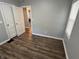 Open bedroom with wood floors and a window, offering great natural light at 937 N Routiers Ave, Indianapolis, IN 46219