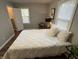 Cozy bedroom with neutral colors, a soft bed, and bright natural light at 937 N Routiers Ave, Indianapolis, IN 46219