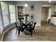 Bright dining area with a glass table, modern light fixture, and shelving at 937 N Routiers Ave, Indianapolis, IN 46219