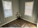A view of the room with wood flooring, two windows and a decorative plant in the corner of the room at 937 N Routiers Ave, Indianapolis, IN 46219