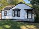 Charming home featuring white siding, black trim and bay window at 937 N Routiers Ave, Indianapolis, IN 46219