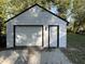 Exterior view of the white-sided garage with black trim and white garage door at 937 N Routiers Ave, Indianapolis, IN 46219