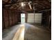 Interior of the detached garage with an open garage door and wood supports at 937 N Routiers Ave, Indianapolis, IN 46219