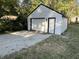Exterior view of the white-sided garage with black trim and white garage door at 937 N Routiers Ave, Indianapolis, IN 46219