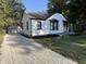 Exterior view of the cottage-style home and detached garage at 937 N Routiers Ave, Indianapolis, IN 46219