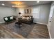 Well-lit living room featuring a modern design, gray walls and hardwood floors at 937 N Routiers Ave, Indianapolis, IN 46219