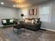 Cozy living room featuring modern furniture, wood floors, and ample natural light at 937 N Routiers Ave, Indianapolis, IN 46219