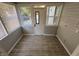 A view of the mud room with tile floors, many windows and a door to the outside at 937 N Routiers Ave, Indianapolis, IN 46219