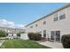 View of the backyard, featuring a patio, well-maintained lawn, and partial fencing at 9707 Prairie Smoke Dr, Noblesville, IN 46060