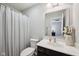 A well-lit bathroom features modern fixtures, a vanity, and a shower curtain at 9707 Prairie Smoke Dr, Noblesville, IN 46060
