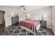 Cozy bedroom showcases a ceiling fan, plush rug, dresser, and modern lamps at 9707 Prairie Smoke Dr, Noblesville, IN 46060