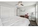 Bedroom with ceiling fan, closet, wood floors, and a pink chair at the desk at 9707 Prairie Smoke Dr, Noblesville, IN 46060