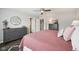 Bedroom with ceiling fan, two dressers and stylish round mirror at 9707 Prairie Smoke Dr, Noblesville, IN 46060