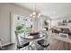 The dining area is open to living room and features a round table and outdoor view at 9707 Prairie Smoke Dr, Noblesville, IN 46060