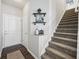 Inviting entryway with a staircase, decorative shelves, and neutral tones creating a warm welcome at 9707 Prairie Smoke Dr, Noblesville, IN 46060