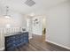 A light-filled hallway with wood floors and decorative accents leads to adjacent rooms at 9707 Prairie Smoke Dr, Noblesville, IN 46060