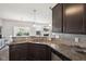 Well-equipped kitchen with stainless steel appliances, granite counters, and seamless flow to living area at 9707 Prairie Smoke Dr, Noblesville, IN 46060