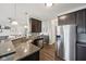 Modern kitchen featuring granite countertops, stainless steel appliances, and wood-look flooring at 9707 Prairie Smoke Dr, Noblesville, IN 46060