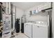 Functional laundry room with washer, dryer, shelving, and laundry supplies at 9707 Prairie Smoke Dr, Noblesville, IN 46060