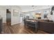 Open-concept living area featuring hardwood floors, a fireplace, and seamless flow to the kitchen at 9707 Prairie Smoke Dr, Noblesville, IN 46060