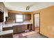 Functional kitchen featuring dark cabinetry, double stainless sink and ample counter space at 10159 Hodge Rd, Clayton, IN 46118